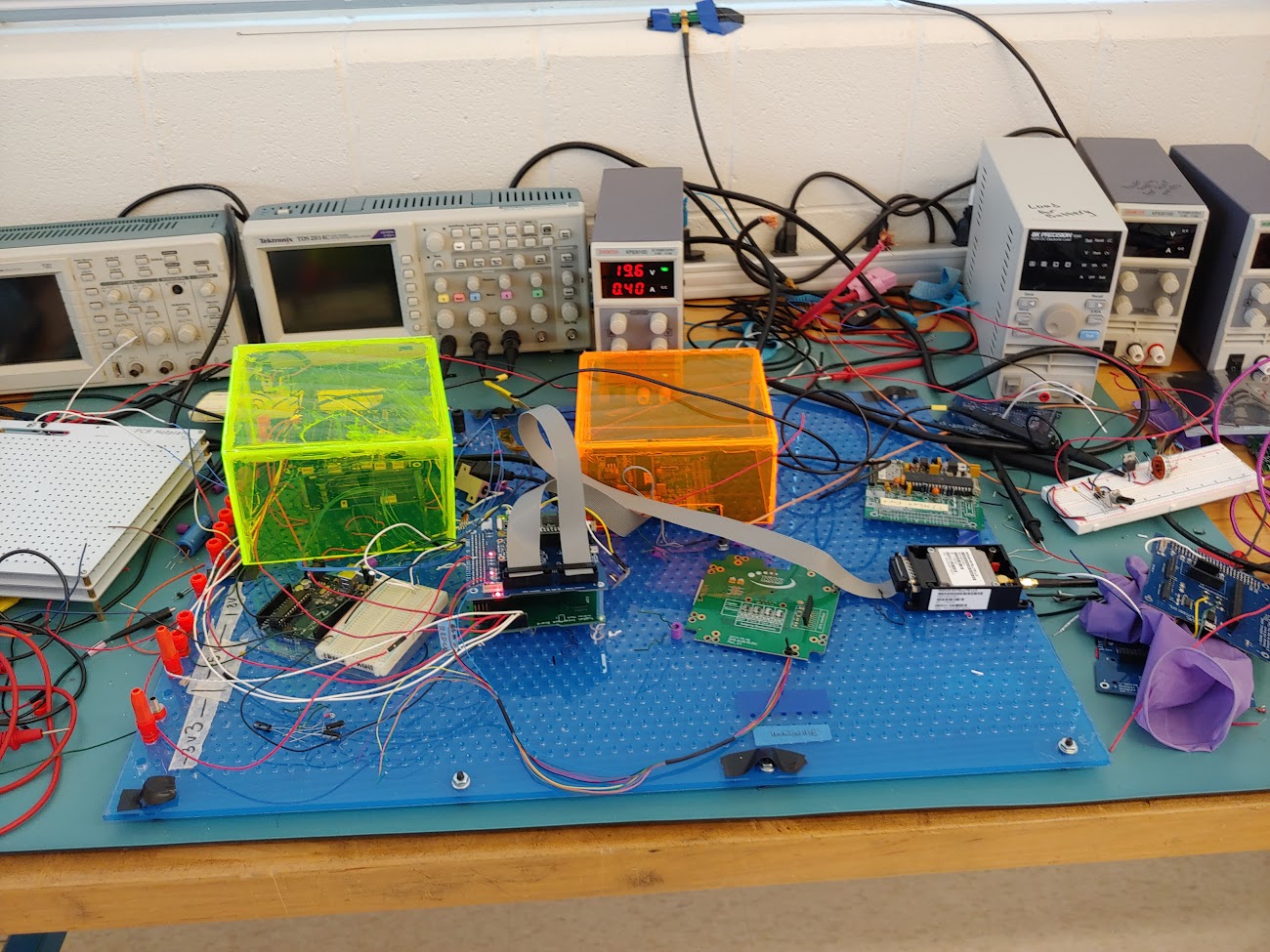 The flatsat around the time I ran the discharge test. Note the hotplates on the left, EPS + Battery stack inside the green box, MOSFETs on a breadboard behind the green box. Load is not powered.